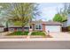 Charming two-story home featuring a landscaped front yard, brick accents, and an attached two-car garage at 18472 E Atlantic Dr, Aurora, CO 80013