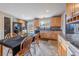 Charming kitchen boasts wood cabinets, modern appliances, tile backsplash, and view to fenced back yard at 18472 E Atlantic Dr, Aurora, CO 80013