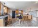 Bright kitchen area with an island, maple cabinets, and modern black backsplash at 18472 E Atlantic Dr, Aurora, CO 80013