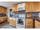 Updated kitchen with maple cabinets, black countertops, and stainless steel appliances at 18472 E Atlantic Dr, Aurora, CO 80013