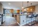 Updated kitchen featuring an island with seating, stylish backsplash, and sliding door access to the backyard at 18472 E Atlantic Dr, Aurora, CO 80013