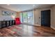 Bright living room featuring wood floors, a large window, and neutral walls at 18472 E Atlantic Dr, Aurora, CO 80013