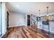 Open living area with hardwood floors, light gray walls, black trim, and stairs leading up at 18472 E Atlantic Dr, Aurora, CO 80013