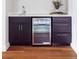 Wet bar with a built-in wine refrigerator, quartz countertop, and dark wood cabinets at 2931 W 20Th Ave, Denver, CO 80211