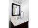 Elegant half-bathroom with modern fixtures, quartz countertop, and dark wood cabinet at 2931 W 20Th Ave, Denver, CO 80211