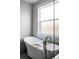 Stylish soaking tub with tray table and adjacent window creating a relaxing spa experience at 2931 W 20Th Ave, Denver, CO 80211