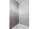 Modern bathroom featuring grey tiles, a shower head, and a tub at 2931 W 20Th Ave, Denver, CO 80211