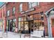 Exterior of a brick coffee shop with outdoor seating and large windows showcasing a cozy interior at 2931 W 20Th Ave, Denver, CO 80211