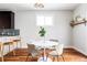 Bright dining area features a white table, stylish chairs, hardwood floors, and ample natural light at 2931 W 20Th Ave, Denver, CO 80211