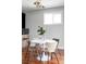 Bright dining room with hardwood floors, round white table, modern chairs, and natural lighting at 2931 W 20Th Ave, Denver, CO 80211