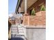 Inviting front porch with brick pillars, metal railing, and concrete steps leading to the entrance at 2931 W 20Th Ave, Denver, CO 80211