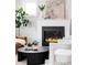 Living room showcasing a fireplace, hardwood floors, a black coffee table, and stylish decor at 2931 W 20Th Ave, Denver, CO 80211
