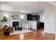Open-concept living room featuring hardwood floors, fireplace, and seamless flow into the modern kitchen at 2931 W 20Th Ave, Denver, CO 80211