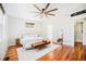 Bright main bedroom with wood floors, neutral decor, bench seat and ceiling fan at 2931 W 20Th Ave, Denver, CO 80211