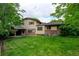 Large backyard with a lush lawn and view of the home's exterior at 800 Mesa Ct, Broomfield, CO 80020