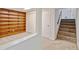 Basement area with built-in bookshelves and adjacent carpeted stairs, offering functional storage and access at 800 Mesa Ct, Broomfield, CO 80020
