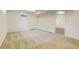Finished basement features neutral carpet, a window, and access to an adjacent room, adding to its functionality at 800 Mesa Ct, Broomfield, CO 80020