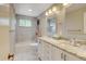 The updated bathroom includes a dual sink vanity, tub with shower, modern lighting, and a large mirror at 800 Mesa Ct, Broomfield, CO 80020