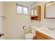 Bright bathroom featuring a classic vanity, toilet, mirrored cabinet, and a window for natural light at 800 Mesa Ct, Broomfield, CO 80020