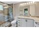Updated bathroom boasts a glass enclosed shower with stone tile and new vanity at 800 Mesa Ct, Broomfield, CO 80020