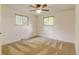 Bedroom featuring a ceiling fan, neutral carpet and natural light from two windows at 800 Mesa Ct, Broomfield, CO 80020