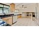 Well-lit eat-in kitchen with stainless appliances, granite counters, a skylight, and view to the living area at 800 Mesa Ct, Broomfield, CO 80020