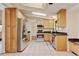 Stylish kitchen with stainless steel appliances, granite countertops, tile floors, and light wood cabinetry at 800 Mesa Ct, Broomfield, CO 80020