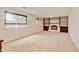 Spacious living room with carpet, a fireplace, custom built-ins, and natural light from a large window at 800 Mesa Ct, Broomfield, CO 80020