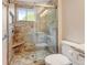 Walk-in shower with glass enclosure features a bench and designer tile at 800 Mesa Ct, Broomfield, CO 80020