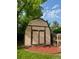 Backyard shows tan storage shed with brown trim, double doors, and vent at 800 Mesa Ct, Broomfield, CO 80020