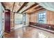 Charming attic bedroom with wood paneled walls and floors, and large windows providing ample natural light at 5502 Santa Clara Rd, Indian Hills, CO 80454