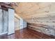 View of attic with exposed wood beam walls, ceiling, and wooden floors at 5502 Santa Clara Rd, Indian Hills, CO 80454