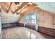 Spacious attic featuring natural light from dual windows, wood paneling and hardwood floors for cozy feel at 5502 Santa Clara Rd, Indian Hills, CO 80454