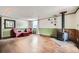 Spacious basement features a cozy stove, accent lighting, and matching armchairs at 5502 Santa Clara Rd, Indian Hills, CO 80454