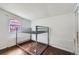 A bedroom featuring wooden floor, a bunk bed frame and a bright window at 5502 Santa Clara Rd, Indian Hills, CO 80454