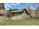 A cozy, green home with a well-maintained lawn and charming details at 5502 Santa Clara Rd, Indian Hills, CO 80454