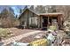 Charming home with a brick pathway, decorative garden features, and comfortable seating area at 5502 Santa Clara Rd, Indian Hills, CO 80454