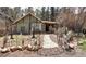 Charming home featuring a brick path and unique garden decor leading to the entrance at 5502 Santa Clara Rd, Indian Hills, CO 80454