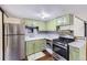 Compact kitchen with marbled counters, retro fixtures, and stainless steel appliances at 5502 Santa Clara Rd, Indian Hills, CO 80454