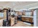 Rustic kitchen featuring classic appliances, custom wood cabinets, and a cozy wood stove at 5502 Santa Clara Rd, Indian Hills, CO 80454