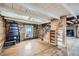 Spacious living area with wood flooring, a fireplace, and a staircase leading upstairs at 5502 Santa Clara Rd, Indian Hills, CO 80454