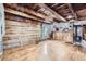 Cozy living area featuring wood paneling, a fireplace, and rustic charm at 5502 Santa Clara Rd, Indian Hills, CO 80454