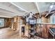 Rustic living room with wood floors, exposed beams, and a cozy wood-burning stove at 5502 Santa Clara Rd, Indian Hills, CO 80454