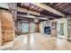 A rustic living room featuring log walls, hardwood floors, and a traditional fireplace and wood beam ceilings at 5502 Santa Clara Rd, Indian Hills, CO 80454