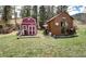 Exterior shot of two small outbuildings named 'Rush' and 'Alice' on a grassy lawn at 5502 Santa Clara Rd, Indian Hills, CO 80454