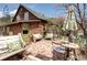 Charming outdoor patio with brick flooring, seating, and lush greenery at 5502 Santa Clara Rd, Indian Hills, CO 80454