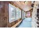 Bright sunroom with wood-paneled walls and ceilings and large windows, offering scenic views of the surrounding area at 5502 Santa Clara Rd, Indian Hills, CO 80454