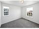 Simple bedroom with grey carpet and two windows at 9437 E 108Th Dr, Commerce City, CO 80640