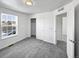 Simple bedroom with grey carpet and a large window at 9437 E 108Th Dr, Commerce City, CO 80640
