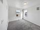 Bright bedroom with two windows, gray carpet, and a closet at 9437 E 108Th Dr, Commerce City, CO 80640